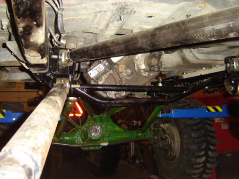 1992 Ford Bronco - Custom suspension and drivetrain components visible on the underside of a heavily modified vehicle.