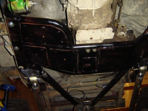 1992 Ford Bronco - The underside of a vehicle is shown, with focus on the frame and drivetrain components, some of which have been painted black.