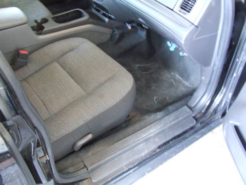 2003 Ford Crown Victoria - Interior view showing the driver's seat, center console, and dashboard area of a vehicle.