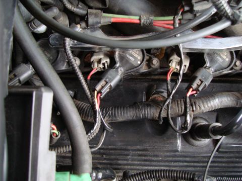 2002 Lincoln Town Car - Close-up view of engine wiring and ignition coils, showing electrical connectors and part numbers.
