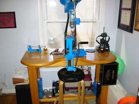 1996 Ford Bronco - A reloading press and radio equipment are set up on a wooden desk by a window.