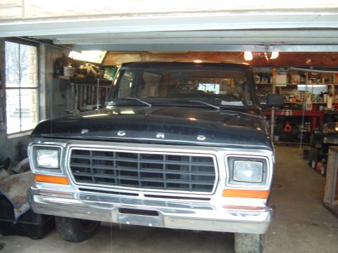 1979 Ford Bronco - Front view of a black 1979 Ford F-Series truck, parked in a garage.
