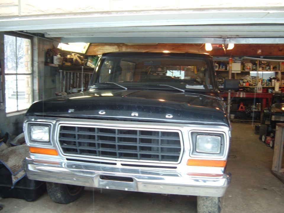 Front view of a black 1979 Ford F-Series truck grille and headlights