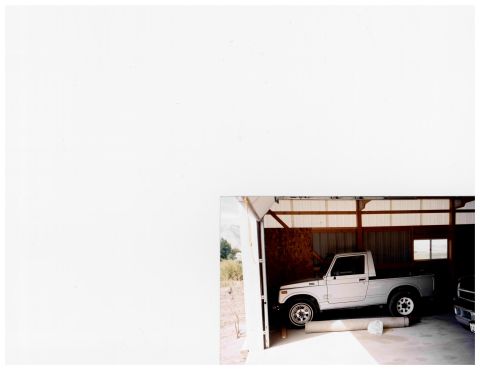 1988 Suzuki Samurai - A silver Suzuki Samurai pickup truck is parked inside a garage, partially covered by a rolled-up carpet.