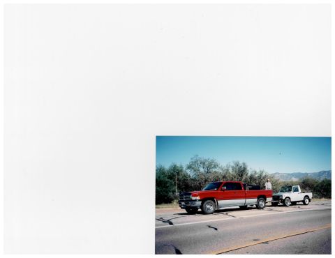 1988 Suzuki Samurai - A red and silver pickup truck is towing a white pickup truck on a road. The scene includes trees and mountains.