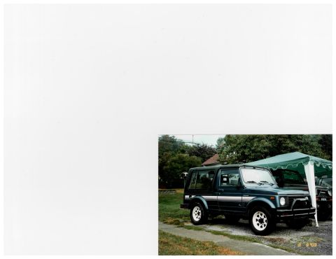 1988 Suzuki Samurai - A dark blue 1988 Suzuki Samurai is parked outdoors under a green tent, with another vehicle partially visible behind it.