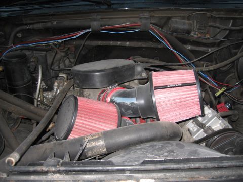 1994 Ford Bronco - Aftermarket performance air filters installed in the engine bay, with visible wiring and engine components.