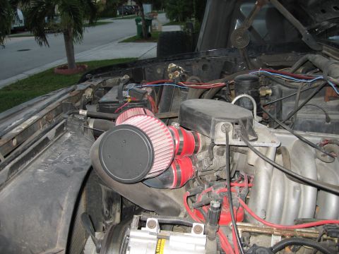 1994 Ford Bronco - Aftermarket intake system installed in the engine bay, dual red cone air filters and custom piping.