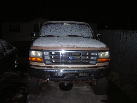 1996 Ford Bronco - Front view of a 1996 Ford Bronco with snow on the hood and windshield.