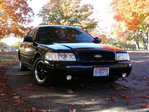 2001 Ford Crown Victoria - Front view of a black 2001 Ford Crown Victoria during the fall season.