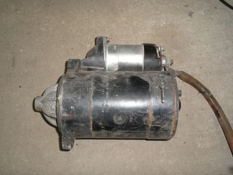 1990 Ford Bronco - A starter motor is pictured, a crucial component for igniting a vehicle's engine.
