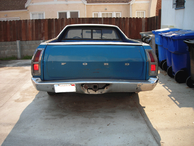 Rear of a blue Ford car-based pickup parked on a driveway