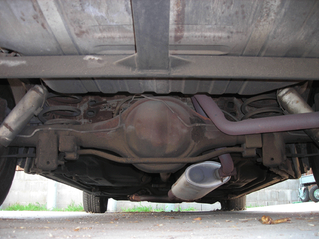 Underside view of a vehicle's rear axle and dual exhaust