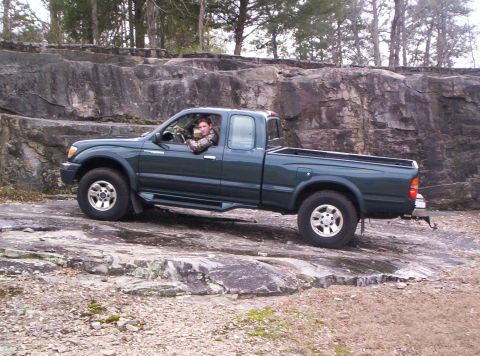 1998 Toyota Tacoma - This 1998 Toyota Tacoma is shown navigating a rocky terrain, demonstrating its off-road capabilities.