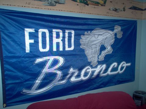 1993 Ford Bronco - A blue flag displaying the Ford Bronco logo hangs on a wall.