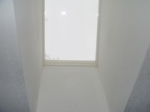 1996 Ford Bronco - The interior of a room with a skylight overhead shows some wear and tear.