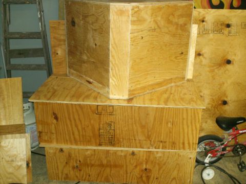 1983 Ford Bronco - Stacked plywood crates dominate the scene, with a red bicycle visible on the right side.
