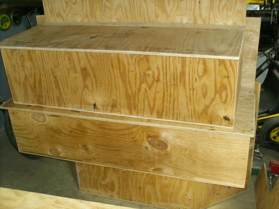 Plywood storage boxes stacked, one with a lid