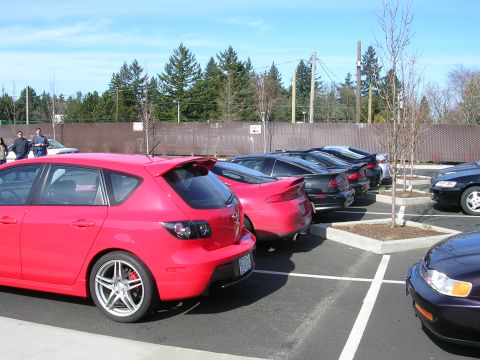 2007 Mazda 3 - Several cars are parked in a lot on a sunny day.