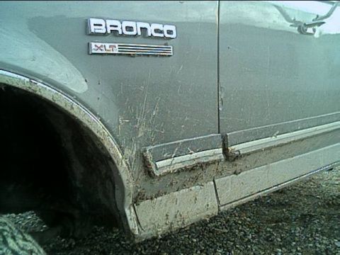 1989 Ford Bronco - Mud-caked side panel of a 1989 Ford Bronco XLT shows off its off-road capabilities.