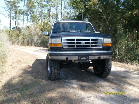 1992 Ford Bronco - This Ford Bronco is parked on a dirt road surrounded by trees. The vehicle has been lifted with large tires.