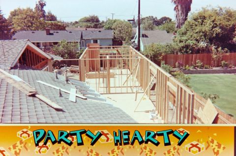 1989 Ford F-250 - Framing for a new addition is underway on a residential property, with a backyard visible.