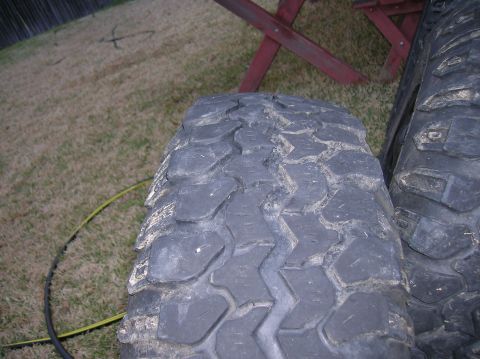 1999 Land Rover Discovery II - Close-up view of two off-road tires, highlighting their tread design and texture.