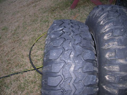 1999 Land Rover Discovery II - Two off-road tires are shown on a grassy surface.