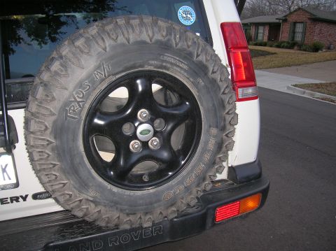1999 Land Rover Discovery II - The rear of a Land Rover Discovery SUV is shown, a mounted spare tire and its distinctive taillight assembly.