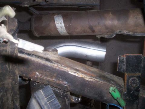 1982 Toyota 4Runner - Underside view of vehicle frame and exhaust system components, showing rust and modifications.