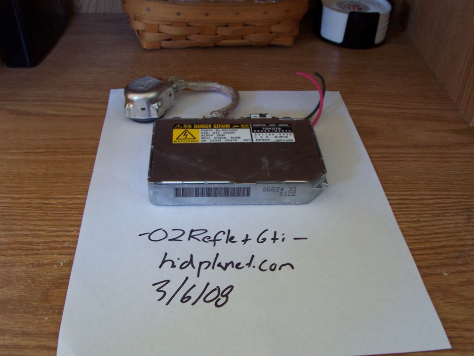 HID ballast and igniter with handwritten "-O2Refle+6ti- hidplanet.com 3/6/09" on paper