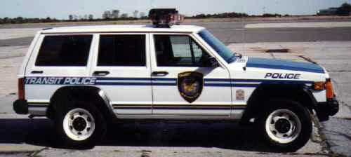 White and blue Jeep Cherokee Transit Police SUV on a tarmac