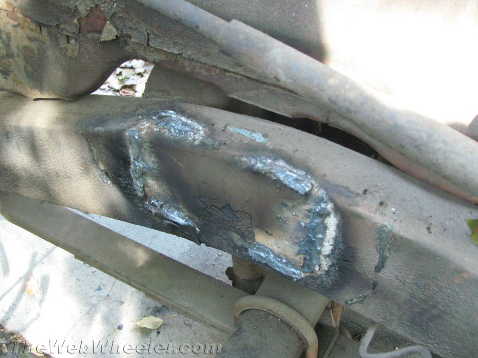 frame section with rough weld repairs and rust holes