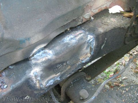 1987 Suzuki Samurai - Close-up view of a vehicle's frame showing repairs and accumulated grime.