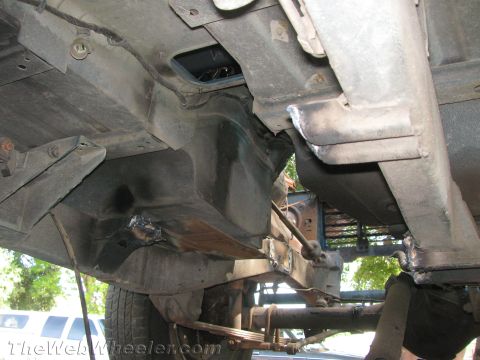 1987 Suzuki Samurai - The underside of a vehicle is shown, with visible suspension components and evidence of repairs.