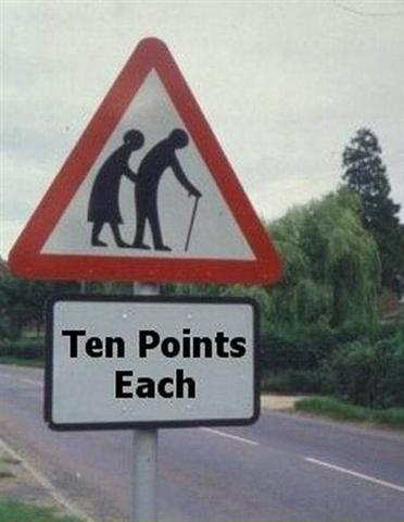 1991 Ford Crown Victoria - A humorous road sign warns drivers with a graphic of elderly pedestrians and a caption about points.