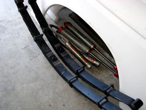 1996 Ford Bronco - Close-up of suspension components, including leaf springs and shock absorbers, with visible branding.