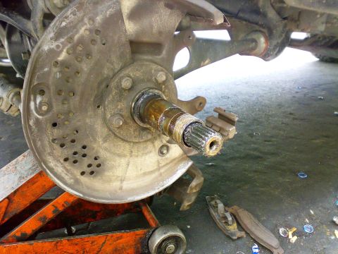 1995 Ford F-150 - Close-up of a vehicle's front wheel hub assembly, showing the axle splines and brake rotor.