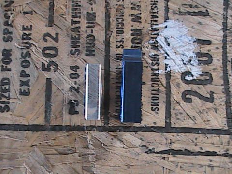 2007 Yamaha YZ450F - Two metal parts are shown on a piece of plywood, which has a date stamp of 2004 visible.