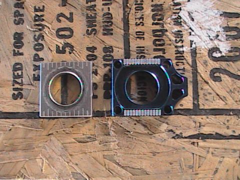 2007 Yamaha YZ450F - Two motorcycle parts are shown on a wooden surface with printed text. The year is unknown.