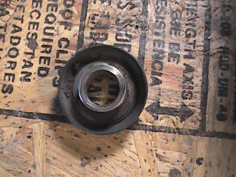 2007 Yamaha YZ450F - Close-up of a motorcycle part with visible text on the wooden surface beneath it.