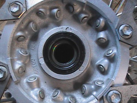 2007 Yamaha YZ450F - A close-up view of a motorcycle's wheel hub, showing the bearing and stamped markings.