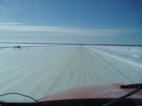 1995 Mercury Grand Marquis - Driving on a snow-covered road with cones marking the path ahead.