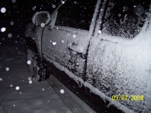 2008 Chevrolet Silverado 1500 - A vehicle is covered in snow during a winter storm. The date stamp indicates March 7, 2008.
