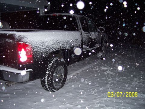 2008 Chevrolet Silverado 1500 - A black pickup truck is seen from the rear in a snowy environment, with a date stamp indicating 03/07/2008.