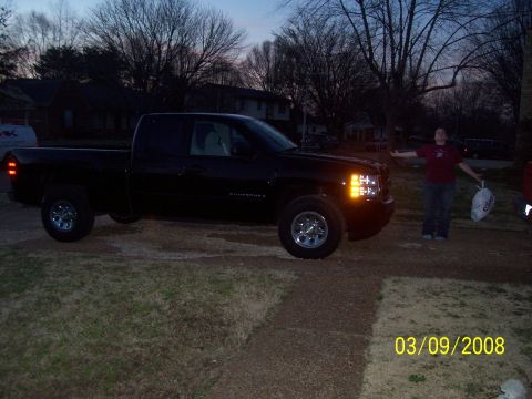 2008 Chevrolet Silverado 1500 - Black pickup truck parked in a driveway at dusk with a person standing nearby.
