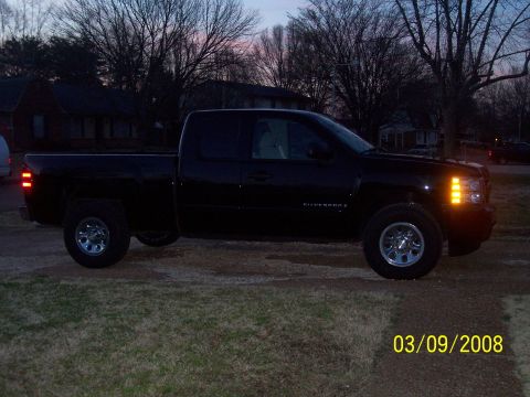 2008 Chevrolet Silverado 1500 - A black Chevrolet Silverado pickup truck is parked outside at dusk, showing its side profile.