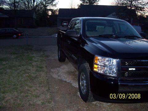 2008 Chevrolet Silverado 1500 - A black pickup truck is parked in a residential driveway at dusk. The date stamp indicates the photo was taken on March 9, 2008.