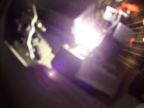 1993 Ford Probe - A close-up view of an engine bay, obscured by bright light and glare.