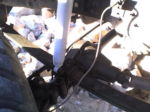 1991 Ford Bronco - This image shows the undercarriage of a vehicle, focusing on suspension parts like the leaf spring and shock absorber.